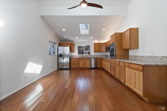 kitchen featuring dark wood-style floors, stainless steel appliances, light countertops, and recessed lighting