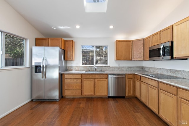 kitchen with dark wood-style floors, appliances with stainless steel finishes, light countertops, and a sink