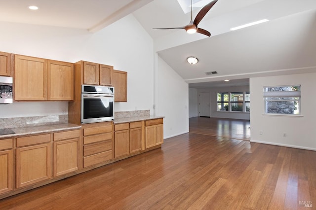 kitchen featuring light countertops, visible vents, appliances with stainless steel finishes, light wood-style floors, and ceiling fan