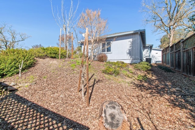 exterior space featuring fence and central AC unit