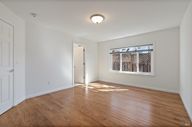 unfurnished bedroom with baseboards and wood finished floors