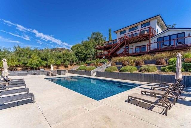 view of swimming pool featuring stairway, a patio area, and a fenced in pool