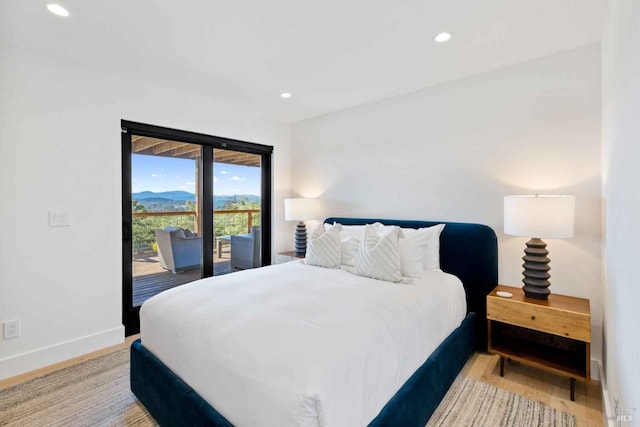 bedroom featuring a mountain view, recessed lighting, baseboards, access to outside, and light wood-type flooring