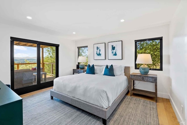 bedroom with light wood finished floors, access to outside, baseboards, and recessed lighting