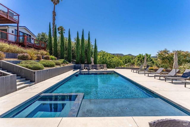 view of pool with a patio and a pool with connected hot tub