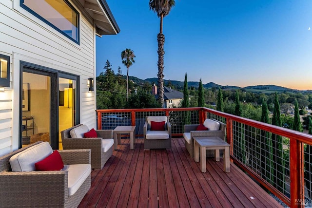 deck featuring a mountain view and an outdoor living space