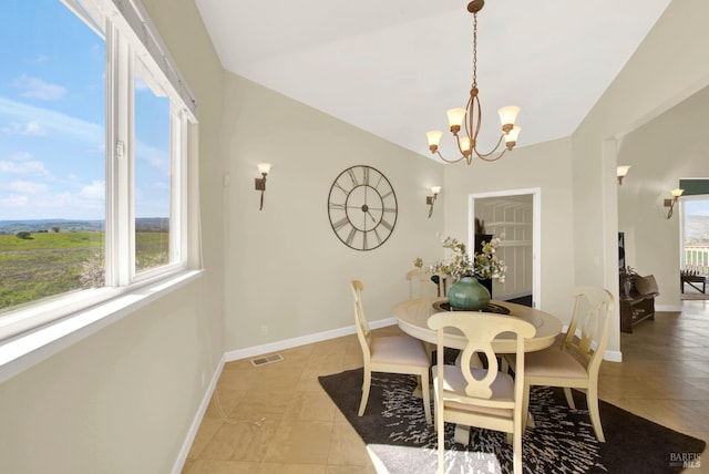 dining space featuring visible vents, vaulted ceiling, baseboards, and an inviting chandelier