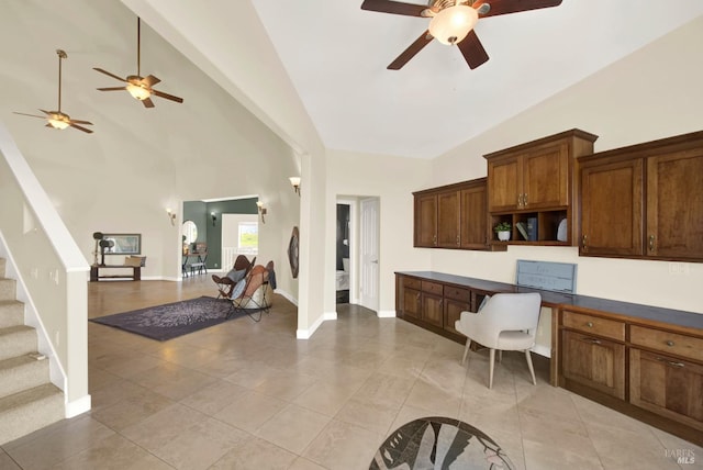 kitchen with light tile patterned floors, baseboards, open floor plan, open shelves, and built in desk