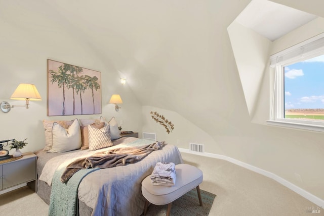 carpeted bedroom with visible vents, vaulted ceiling, and baseboards