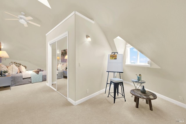 additional living space featuring ceiling fan, carpet floors, vaulted ceiling with skylight, and baseboards