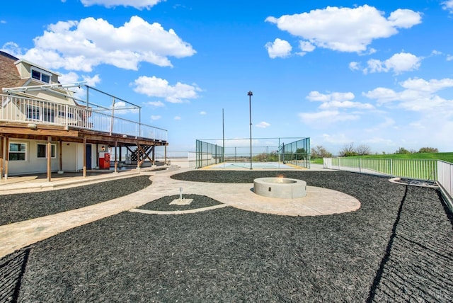 surrounding community featuring a fire pit, a patio, stairs, fence, and a deck