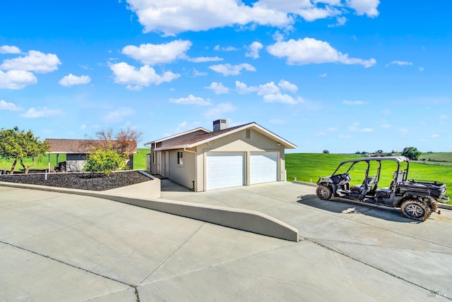 exterior space featuring a lawn, a chimney, and stucco siding