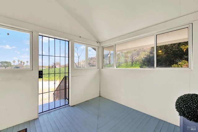 unfurnished sunroom with a healthy amount of sunlight and vaulted ceiling