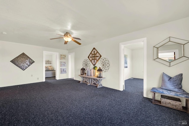 sitting room with carpet floors and a ceiling fan