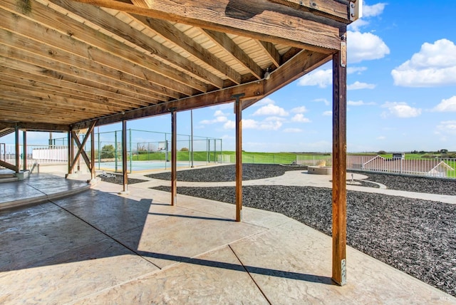 view of patio / terrace with a fire pit and fence