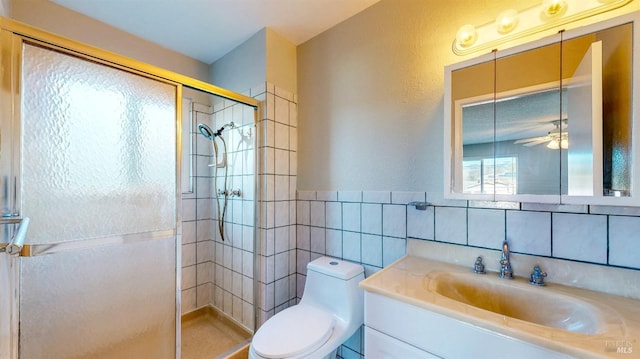 full bath featuring ceiling fan, toilet, vanity, tile walls, and a shower stall