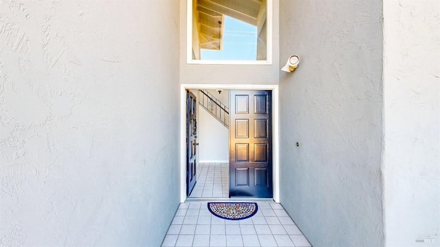 entrance to property featuring stucco siding