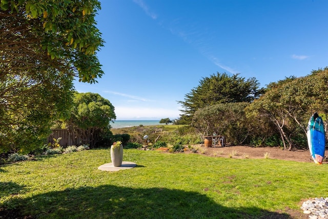 view of yard featuring a water view and fence