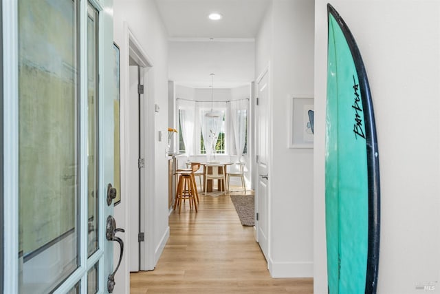 hall with light wood-style floors, recessed lighting, and baseboards