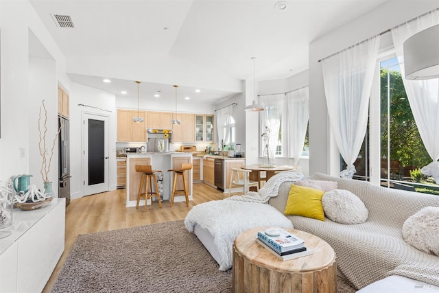 interior space with light wood-style flooring, recessed lighting, visible vents, and a healthy amount of sunlight