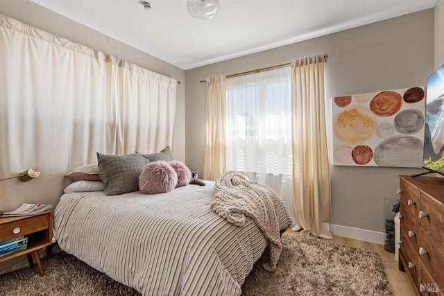 bedroom featuring multiple windows and baseboards