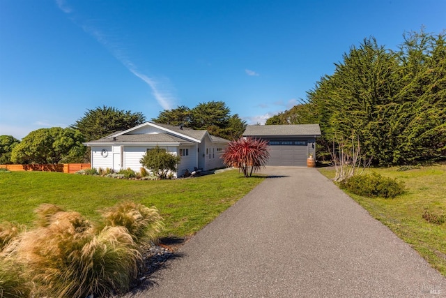 single story home with a garage, fence, and a front lawn