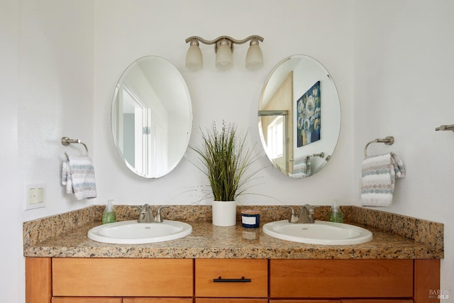 full bathroom featuring double vanity and a sink