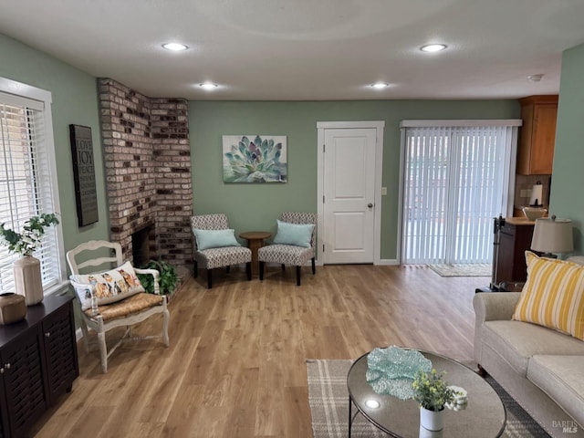 living area with recessed lighting, baseboards, and light wood finished floors