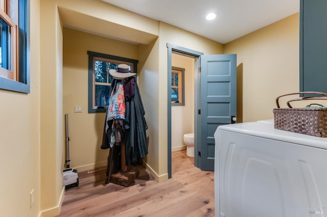 washroom featuring baseboards, washer / clothes dryer, recessed lighting, and light wood-style floors