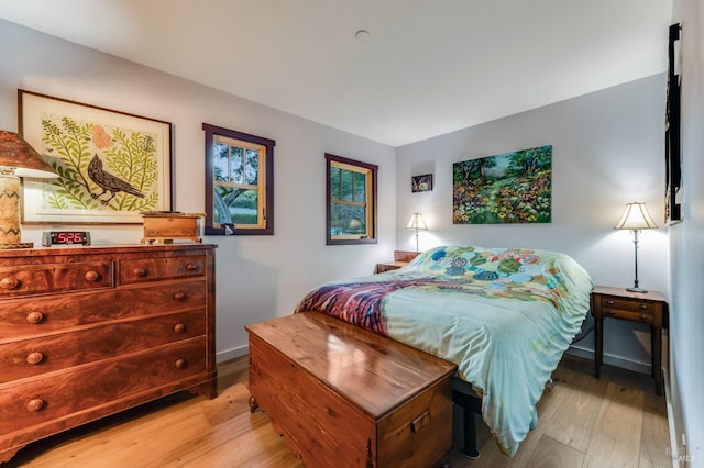 bedroom with baseboards and wood finished floors