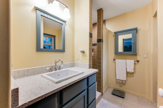 bathroom featuring tile patterned flooring, vanity, and baseboards