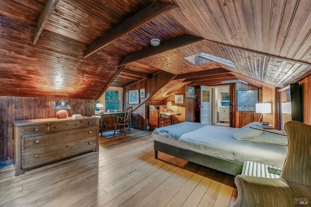 bedroom with vaulted ceiling with beams, hardwood / wood-style floors, wood walls, and wooden ceiling