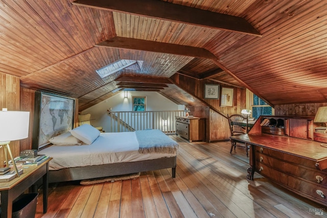 bedroom featuring lofted ceiling with skylight, wood ceiling, hardwood / wood-style floors, and wood walls