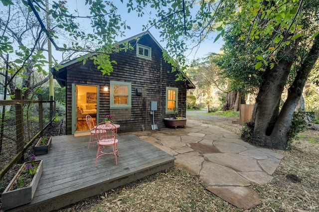 back of house featuring fence and a deck