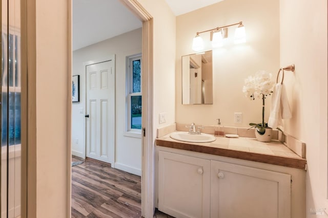 bathroom featuring wood finished floors and vanity