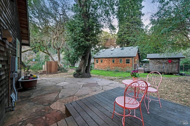 deck with an outbuilding and a patio