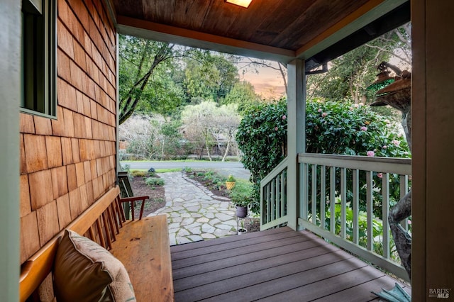 deck at dusk featuring a patio