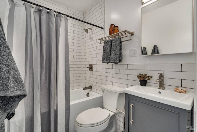 bathroom with shower / tub combo, decorative backsplash, toilet, vanity, and tile walls