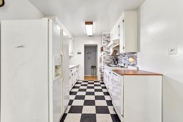 kitchen with tile patterned floors, white appliances, white cabinetry, and under cabinet range hood