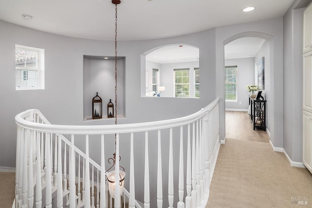 hall with recessed lighting, light colored carpet, and baseboards