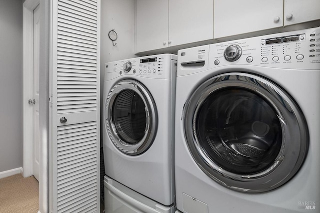 laundry room with washer and clothes dryer, carpet, and cabinet space