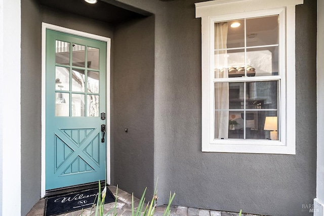 property entrance featuring stucco siding