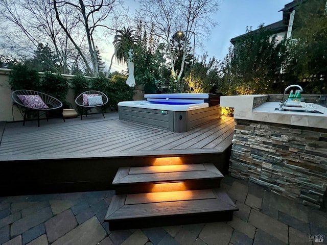 wooden terrace featuring a covered hot tub