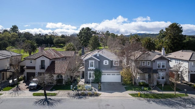 view of front of home featuring a garage, a residential view, and driveway