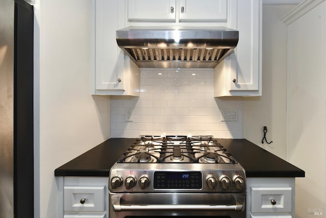 kitchen with appliances with stainless steel finishes, dark countertops, backsplash, and exhaust hood