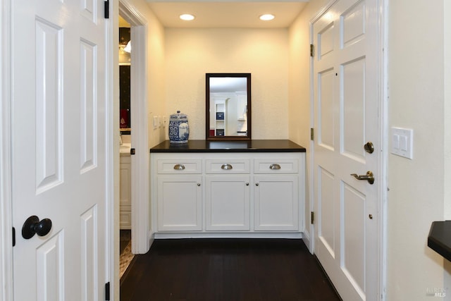 bathroom with recessed lighting, wood finished floors, and vanity