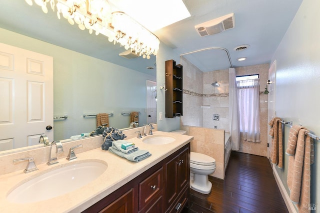 bathroom with visible vents, a sink, and toilet