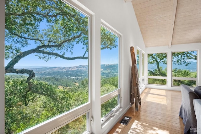 sunroom / solarium featuring wooden ceiling, visible vents, and lofted ceiling with beams