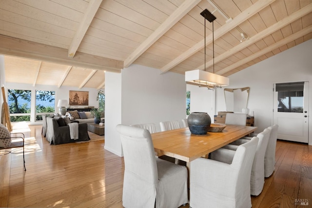 dining room featuring wood-type flooring, wooden ceiling, and vaulted ceiling with beams