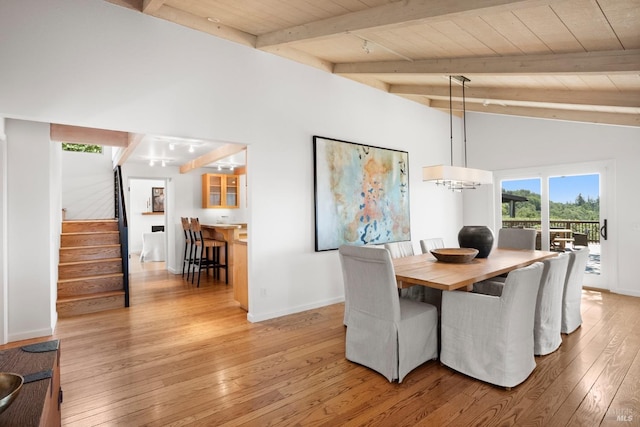 dining area with wooden ceiling, light wood-style floors, stairway, and beamed ceiling